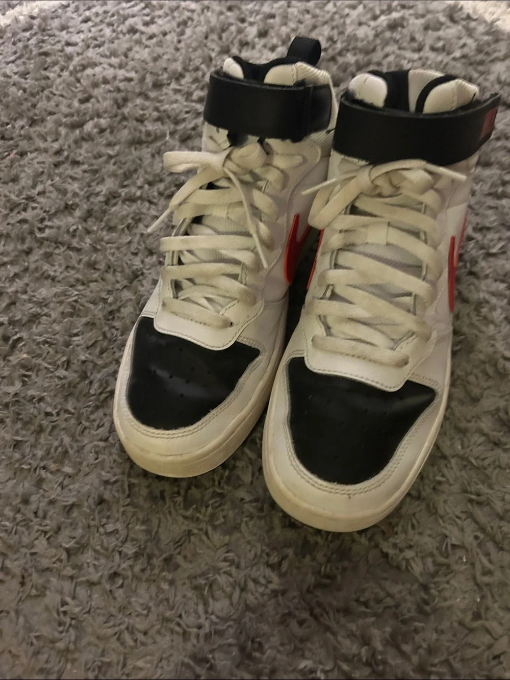 Nike White High-Top Sneakers with Black Toe and Red Swoosh Accent